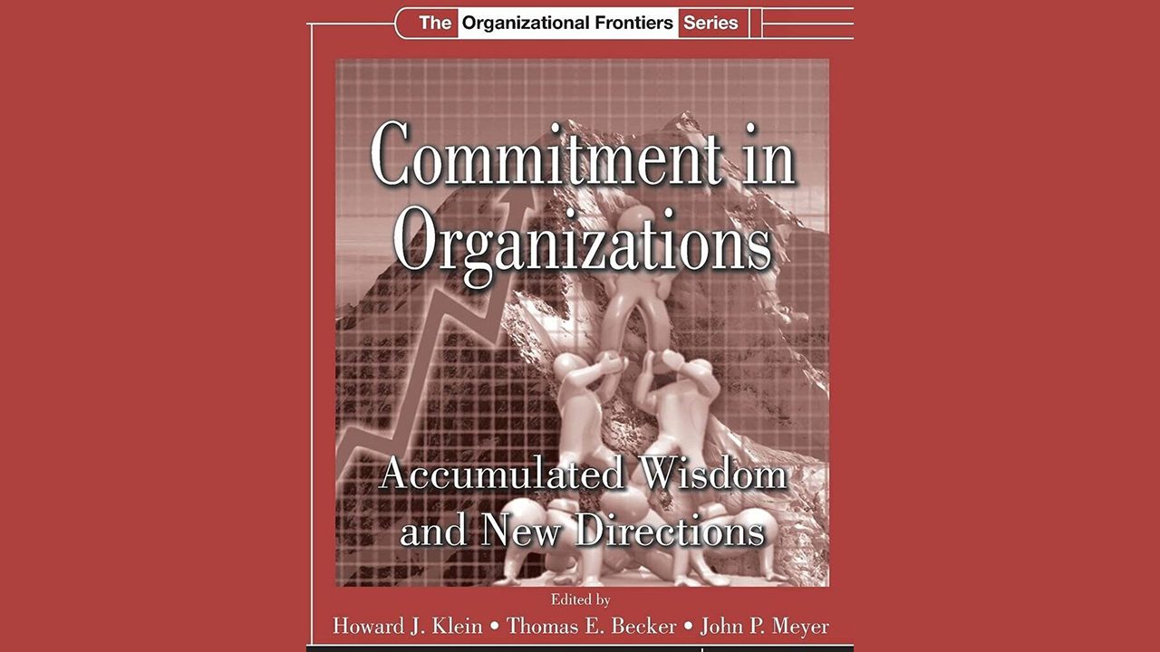 Book cover of 'Commitment in Organizations' featuring a red background with a graph image.