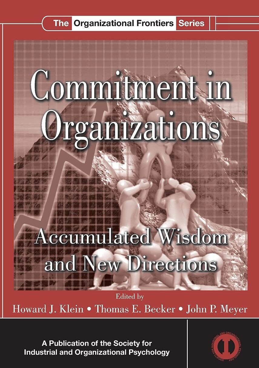 Cover of 'Commitment in Organizations' book with classical statue and grid background.